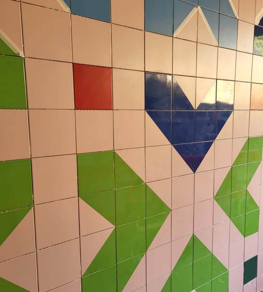 Colourful shapes tiled onto the wall of Dewsbury underpass