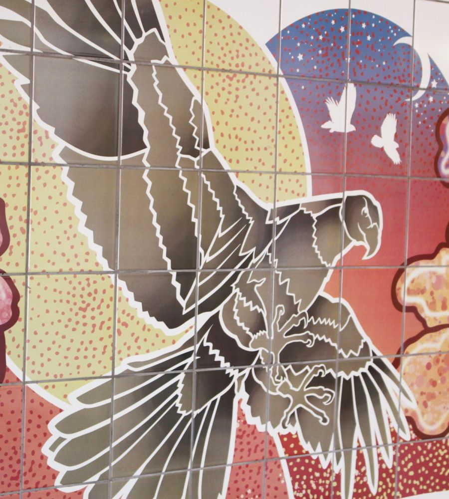 A tiled wall featuring a hawk