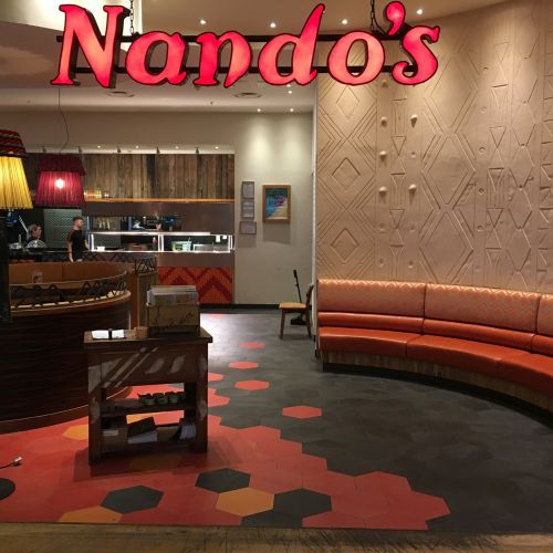 Custom printed hexagon ceramic floor tiles at a Nando's restaurant
