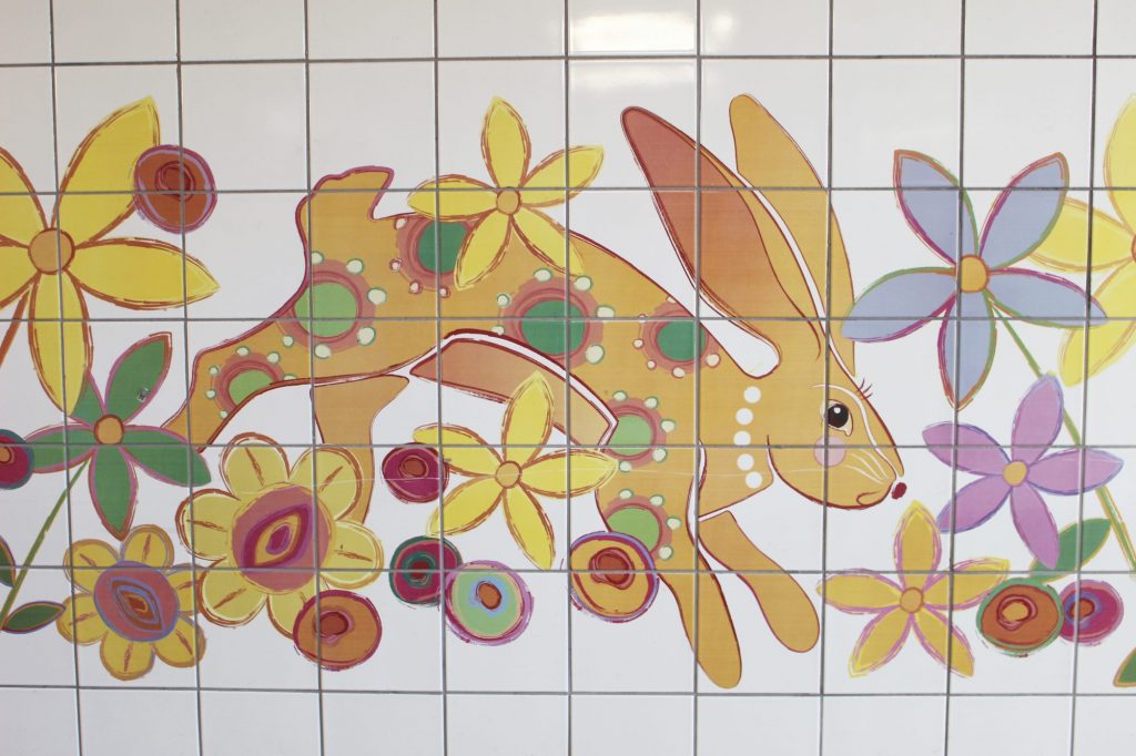 A tiled wall mural featuring an image of a bunny rabbit